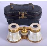 A PAIR OF ANTIQUE MOTHER OF PEARL BINOCULARS with leather case. 9 cm x 6.5 cm extended.