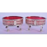 A REGENCY PAIR OF SILVER SALTS WITH RED GLASS LINERS. Hallmark London 1816, 4.5cm x 8.2cm x 6cm, wei