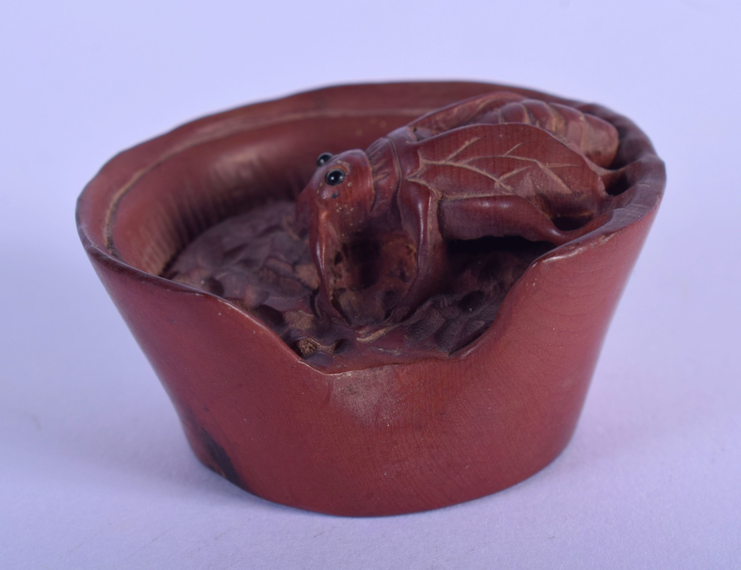 A JAPANESE BONE NETSUKE CARVED AS AN INSECT IN A BASKET. 4.7cm diameter, 2.5cm high, weight 21g