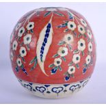 A TURKISH OTTOMAN KUTAHYA FAIENCE TYPE HANGING MOSQUE BALL painted with flowers. 15 cm x 11 cm.