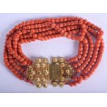 A CHINESE FIVE STRAND CORAL BEAD NECKLACE WITH 18CF GOLD MOUNTS. 28cm long, beads 8mm diameter. 24