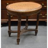 A SMALL 19TH CENTURY CONTINENTAL WICKER UPHOLSERED STOOL inset with a large floral roundel. 52 cm x