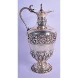 AN INDIAN SILVER JUG HIGHLY DECORATED WITH GOD LIKE FIGURES. 26cm x 15cm, weight 518g