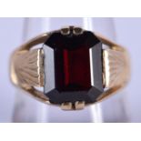 A 9CT GOLD AND GARNET RING. Size Q/R, weight 7.22g