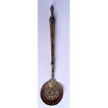 A 19TH CENTURY MIDDLE EASTERN ISLAMIC TYPE HEATING SPOON decorated with foliage. 50 cm long.