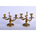 A PAIR OF 19TH FRENCH ORMOLU CANDLESTICKS of scrolling classical form. 24 cm x 21 cm.