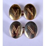 A PAIR OF 15CT GOLD CUFFLINKS EACH MONOGRAMMED WITH AND "M" AND AN "N". Size 1.8cm x 1.3cm, weight