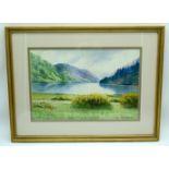 A framed watercolour by Liam O'Kennedy of a lake 24 x 38cm.