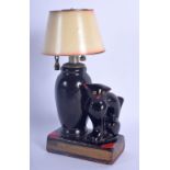 A RARE VINTAGE EVANUS POTTERY CAT TABLE LIGHTER modelled beside a lamp. 14 cm x 7 cm.