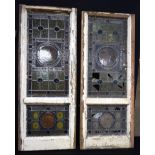 Two antique wooden framed leaded stain glass windows with a floral design 128 x 52cm. (2)