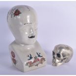 A CONTEMPORARY POTTERY PHRENOLOGY HEAD together with a silvered bronze model of a skull. Largest 30