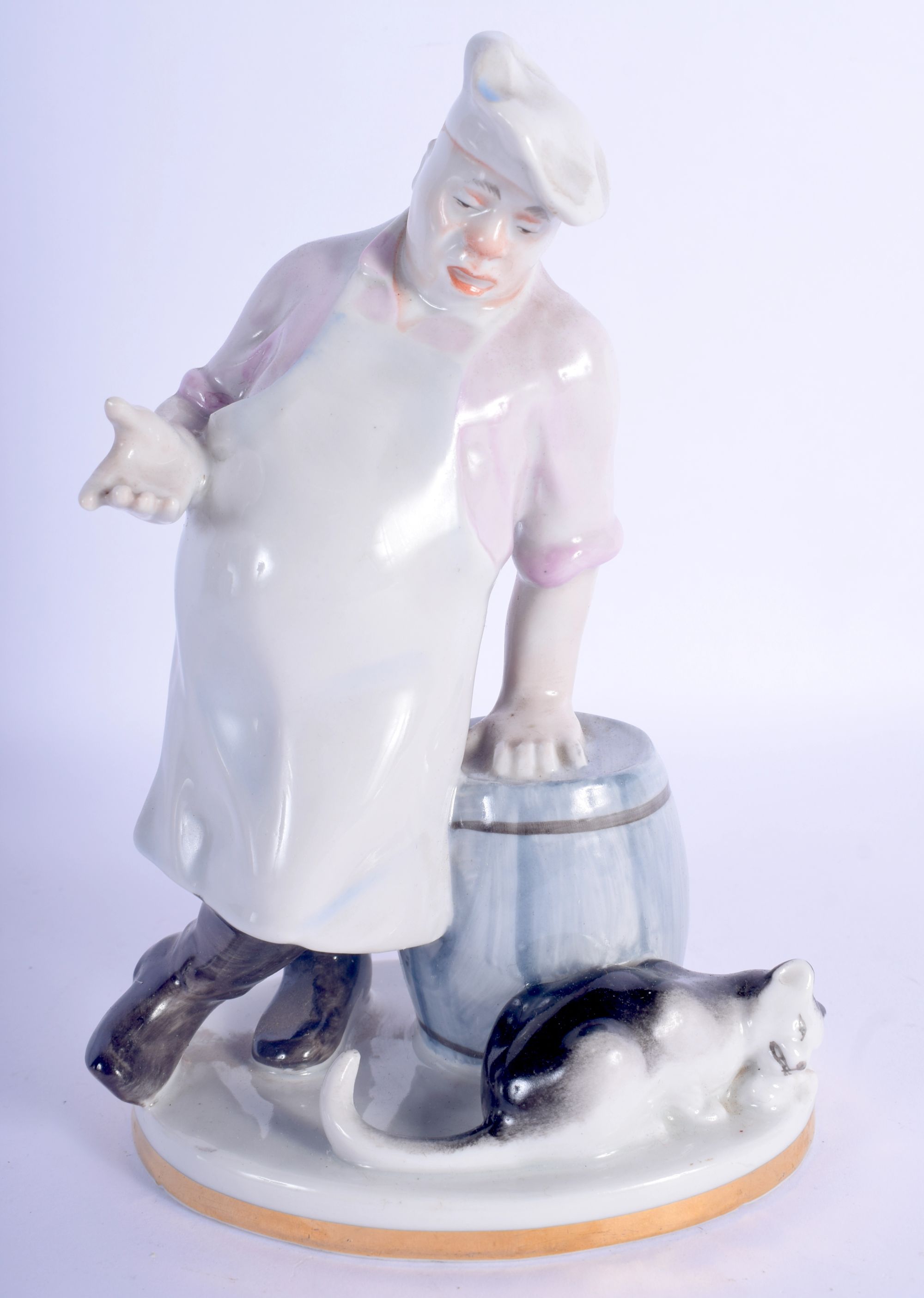 A USSR PORCELAIN FIGURE OF A CHEF modelled beside a cat. 19 cm high.