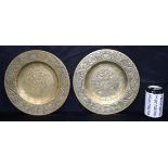 A pair of heavy Chinese bronze dishes engraved with dragons and warriors. 26cm (2)