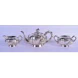 A 19TH CENTURY CHINESE EXPORT THREE PIECE SILVER TEASET by Luen Wo, overlaid with dragons. 940 grams