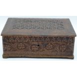 A carved wooden lidded box probably Indian containing some lace items. 10 x 28cm (4)
