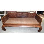 AN EARLY 20TH CENTURY CHINESE CARVED HARDWOOD DAY BED Late Qing/Republic, decorated with stylised dr