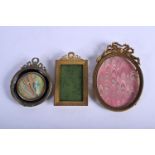 THREE EARLY 20TH CENTURY NEO CLASSICAL EMPIRE STYLE BRASS PHOTOGRAPH FRAMES in various forms and siz
