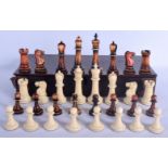 A FINE EARLY 19TH CENTURY CONTINENTAL CARVED AND STAINED IVORY CHESS SET within an antique wooden bo