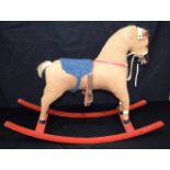 A small mid century stuffed cloth child's rocking horse 63 x 86 cm.