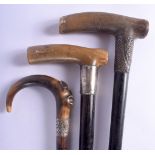 TWO 19TH CENTURY CONTINENTAL CARVED RHINOCEROS HORN HANDLED WALKING CANES together with another horn