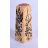 A 19TH CENTURY CHINESE IVORY DESK SEAL DECORATED WITH MYTHICAL CREAURES. 6.3cm high, 2.4cm wide, we
