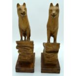 A pair of carved wooden sculptures of Wolves 45cm (2).