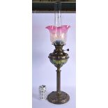 AN ART NOUVEAU BRASS AND VASELINE GLASS CANDLESTICK OIL LAMP decorated with motifs. 75 cm high inc f