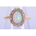 A GOLD, OPAL AND DIAMOND CLUSTER RING. Size H, weight 4g