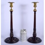 A PAIR OF MAHOGANY AND BRASS CANDLESTICKS. 37 cm high.