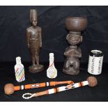 An African wooden figure of a Colonial soldier, together with another wooden figure & a quantity of