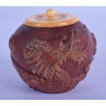 A JAPANESE WOOD BOX CARVED WITH A DRAGON WITH A BONE TOP. 6cm diameter, 6cm wide, weight 65g
