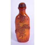 AN AMBER SNUFF BOTTLE CARVED IN RELIEF WITH STORKS. 9cm high, 3.5cm wide