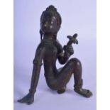 A 19TH CENTURY INDIAN BRONZE FIGURE OF A SEATED FEMALE modelled holding a floral sprig. 13 cm x 8 cm