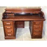 A large wooden American roll top back desk with a tambour front 107 x 152 x 92cm