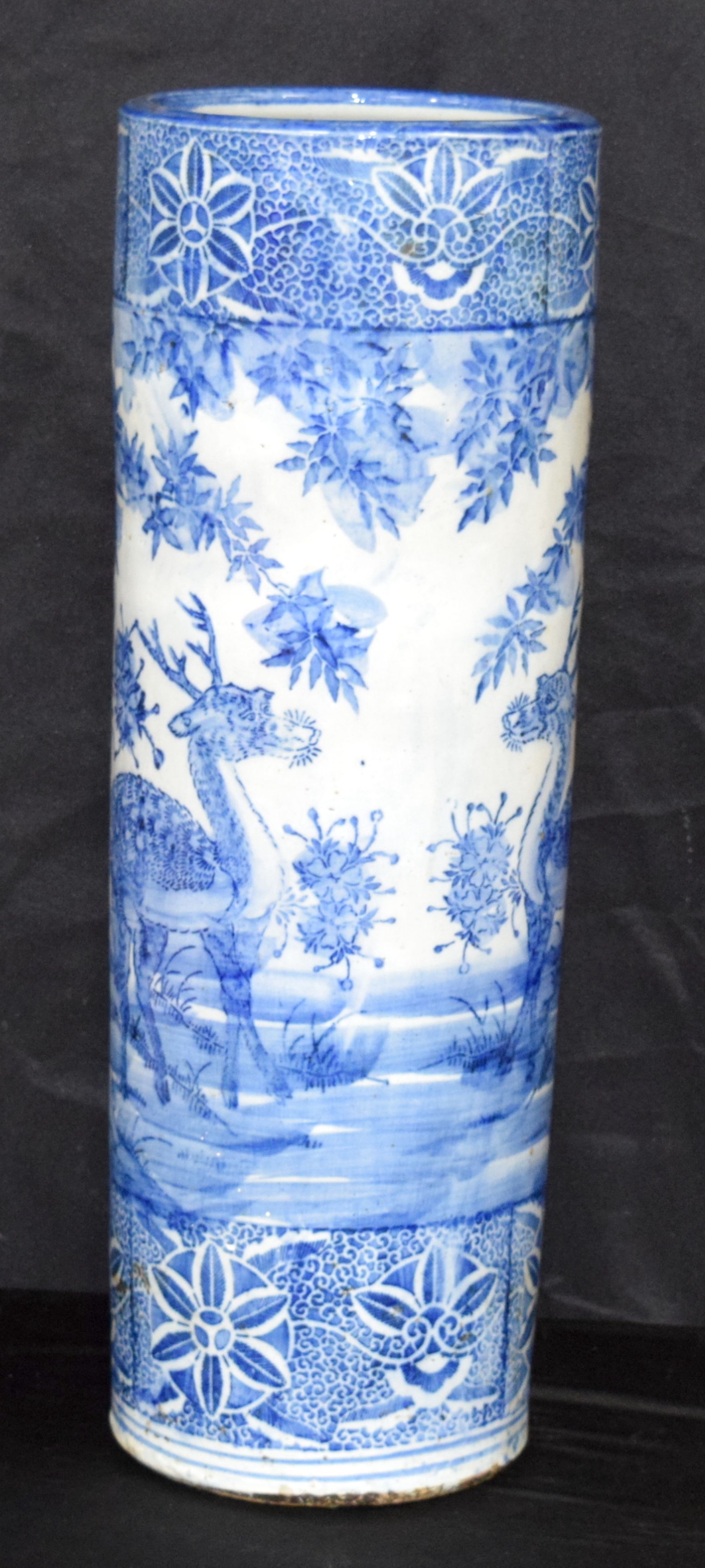 A Japanese porcelain stick stand decorated with deer and foliage. 62 x 22 cm.