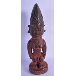 AN AFRICAN TRIBAL CARVED WOOD FIGURE OF A MALE modelled with geometric motifs. 29 cm high.
