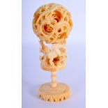 AN EARLY 20TH CENTURY CHINESE CARVED IVORY PUZZLE BALL ON STAND formed with a horse holding aloft a