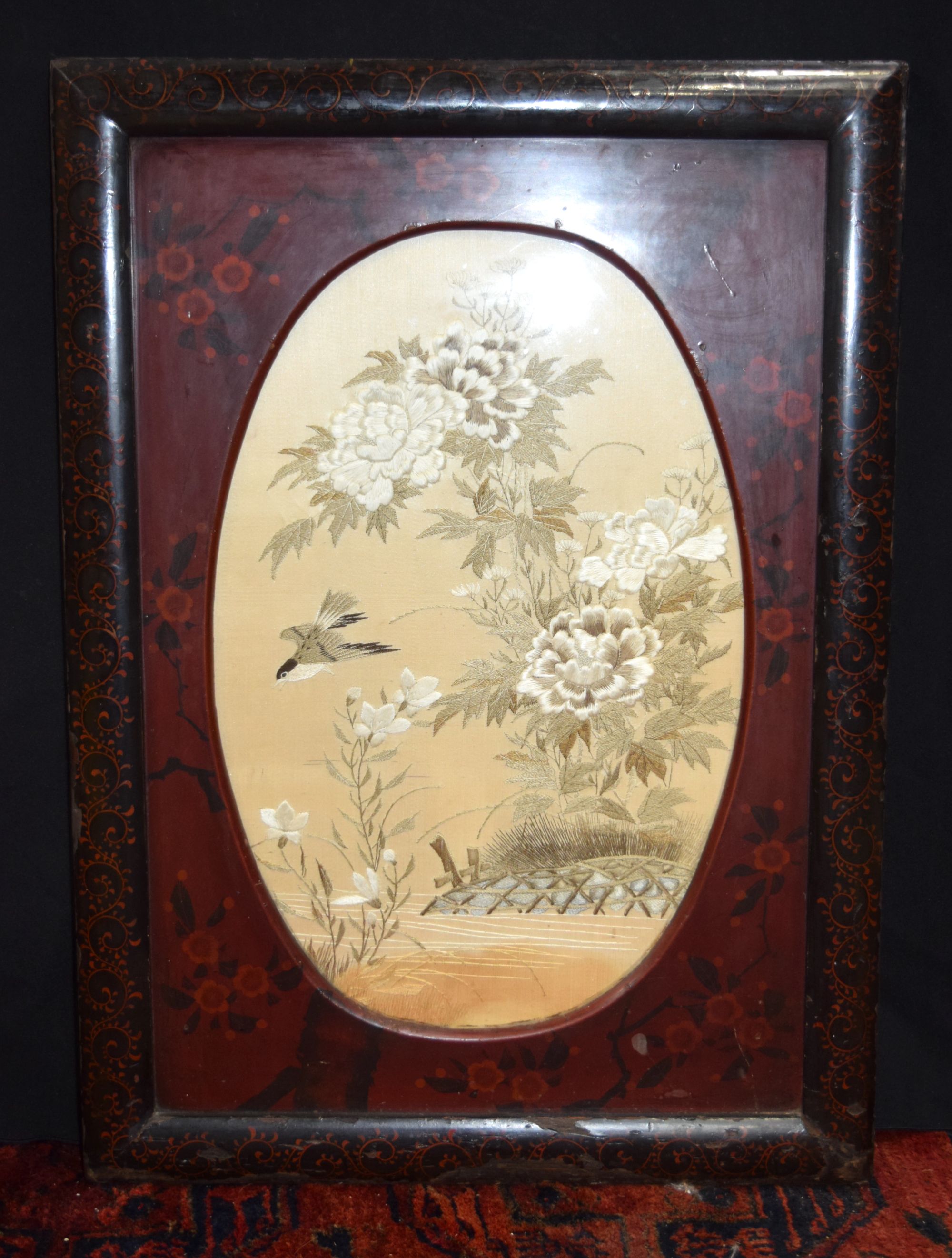 A framed Chinese silk depicting birds in foliage.54 x 36 cm.