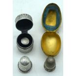 A silver pill box together with another 1892 silver thimble in a gilt box (2).