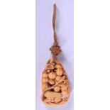 A RARE 19TH CENTURY CHINESE CARVED IVORY PENDANT Qing, modelled as a squirrel nibbling grapes. 5 cm