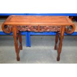 A 19TH CENTURY CHINESE HARDWOOD SCROLLING ALTAR TABLE Qing, decorated with stylised birds. 110 cm x