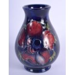 A SMALL MOORCROFT PANSY PATTERN VASE. 9.5cm high, 6.5cm, wide