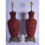 A LARGE PAIR OF 19TH CENTURY CHINESE CARVED CINNABAR LACQUER VASES converted to lamps, carved with f