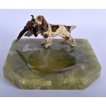 AN ART DECO COLD PAINTED BRONZE ASHTRAY modelled as a hound holding a game bird. 17 cm x 17 cm.