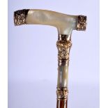 AN ANTIQUE 18CT GOLD AND MOTHER OF PEARL WALKING CANE. 86 cm long.