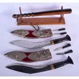 A PAIR OF ANTIQUE MIDDLE EASTERN INDIAN WHITE METAL KUKRI with horn handles, together with a lignum