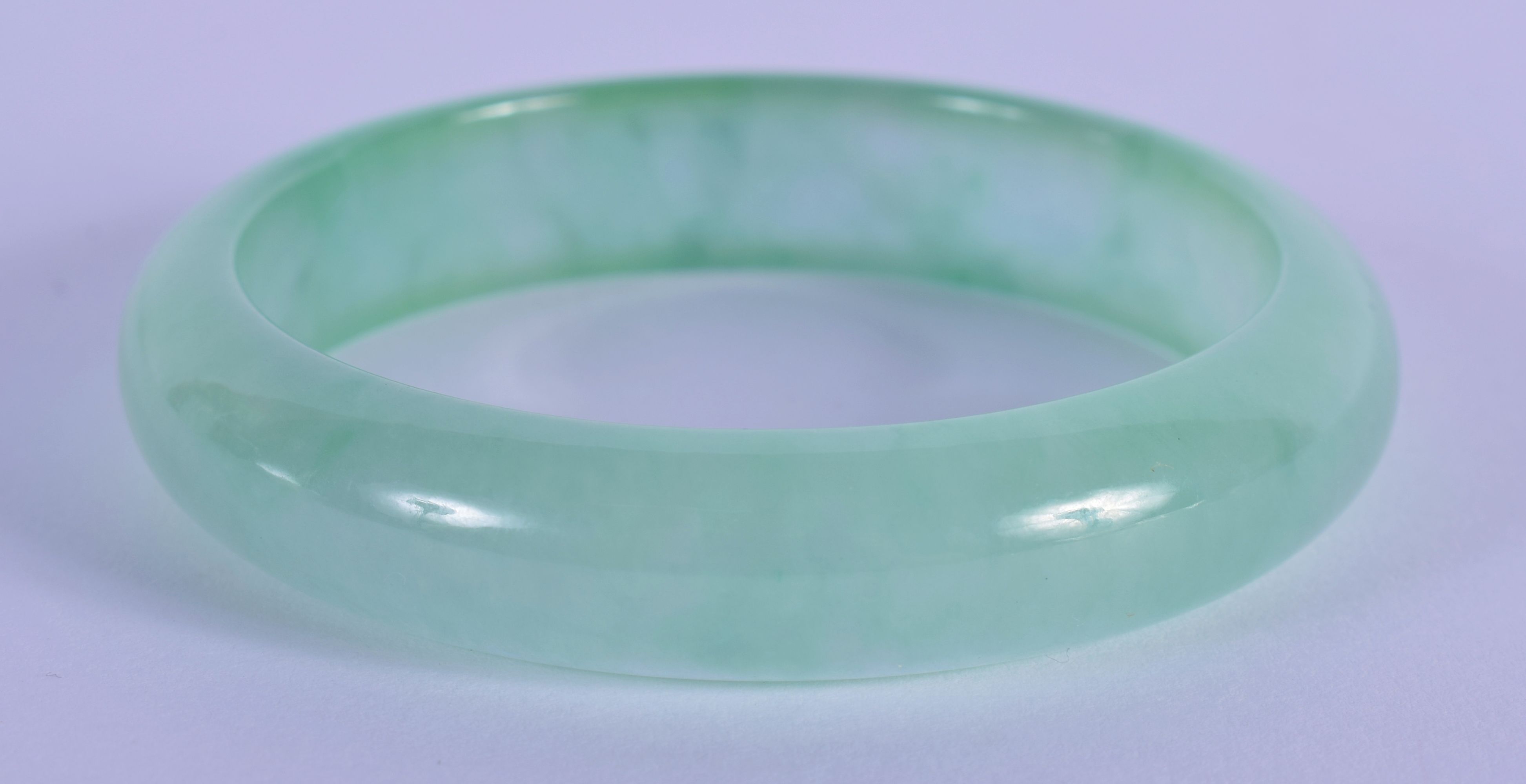 A 20TH CENTURY CHINESE CARVED ICY JADE BANGLE . 7cm Diameter