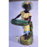 A LARGE ANTIQUE MAJOLICA FIGURE OF A BLACKAMOOR modelled holding a basket. 78 cm x 35 cm.