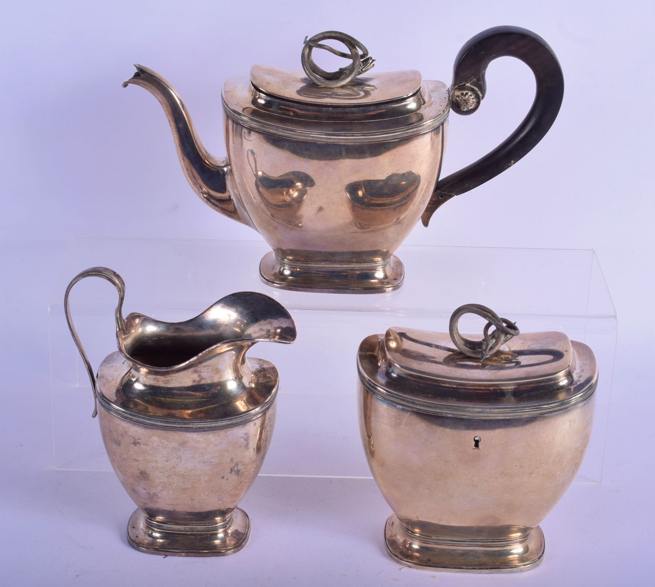 A 19TH CENTURY EUROPEAN SILVER SERPENT TEAPOT together with a similar tea caddy and cream jug. 1001