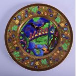 A FINE WEDGWOOD FAIRYLAND LUSTRE PORCELAIN DISH painted with magical figures roaming within a landsc